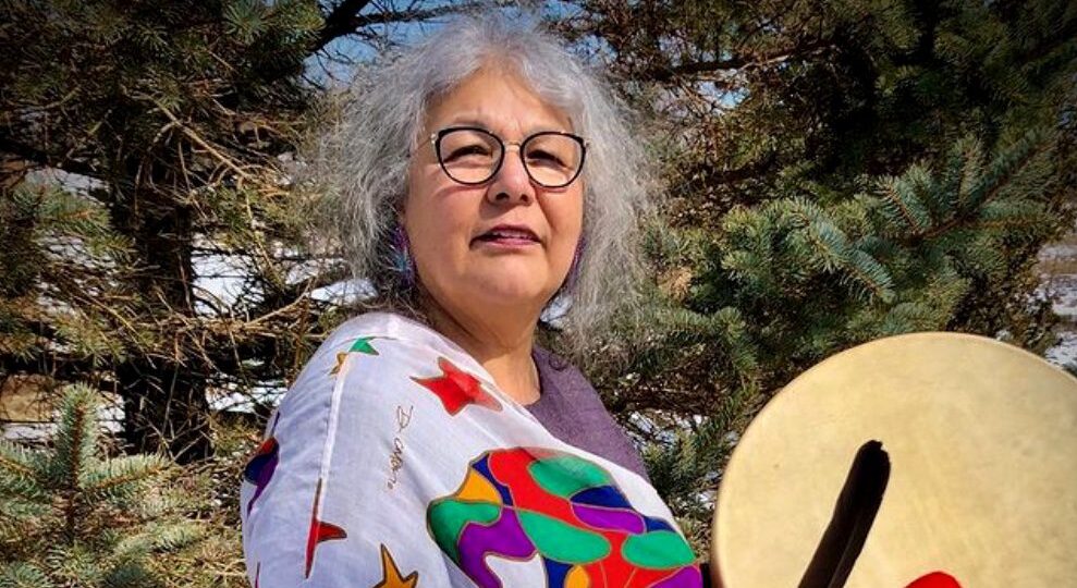 Portrait of Elder Dr. Lorraine Peters-Whitman holding a hand drum